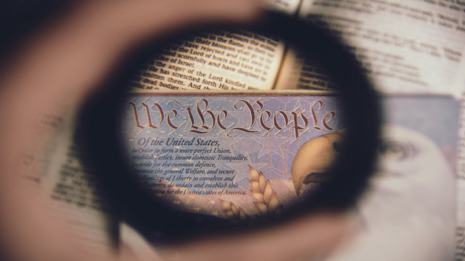 magnifying glass focusing on We The People text