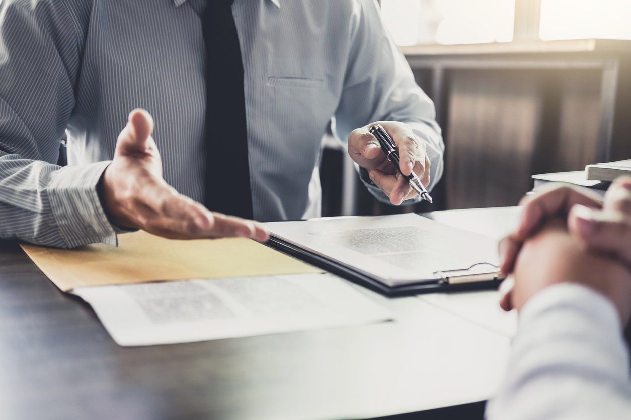 An attorney advising a business owner of their legal obligations.